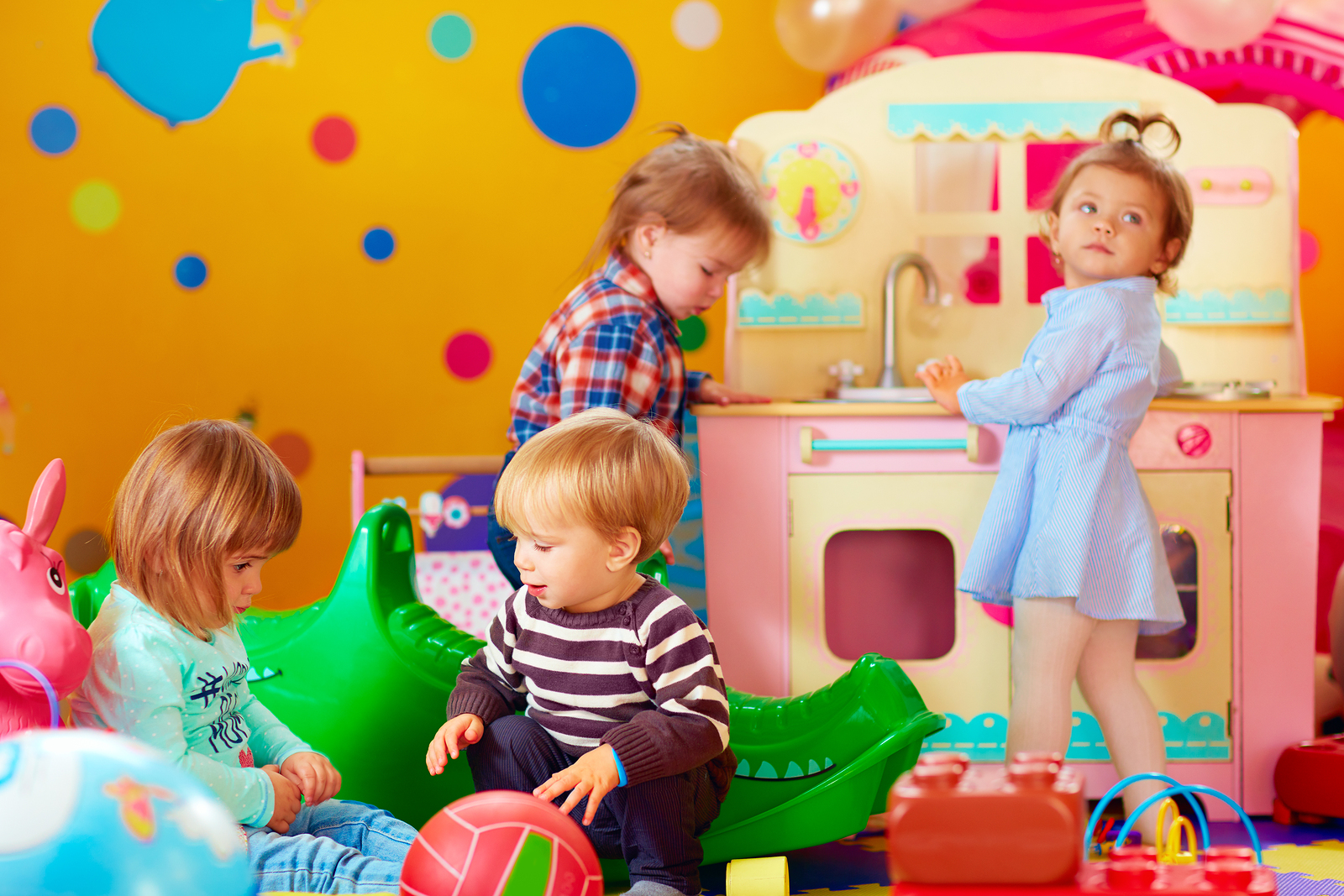 cute little kids playing with toys in nursery group of kindergarten
